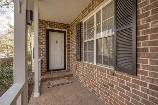 a view of a brick house with a large window