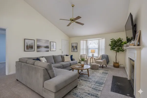 a living room with furniture and a potted plant