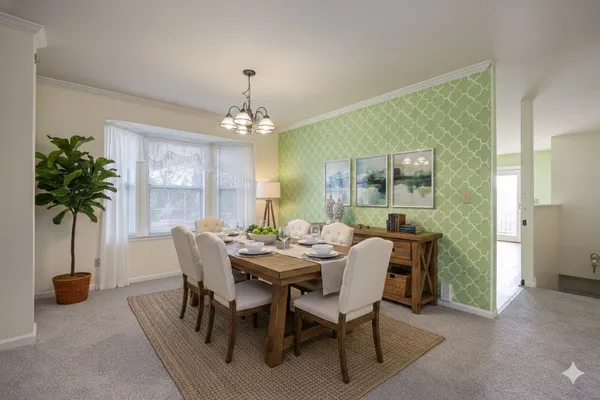 a view of a dining room with furniture and a potted plant
