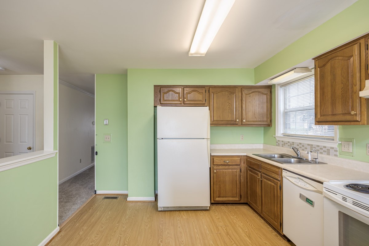 230 Pepper Ridge Circle Antioch, TN 37013 - Photo 7 of 21 a kitchen with a sink a refrigerator and a stove top oven
