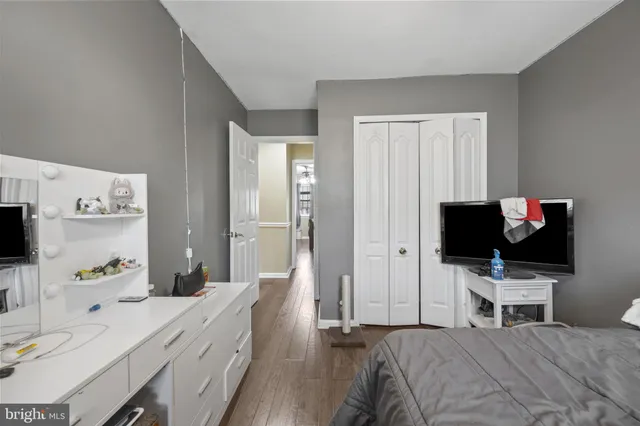 a spacious bedroom with a bed and a chandelier