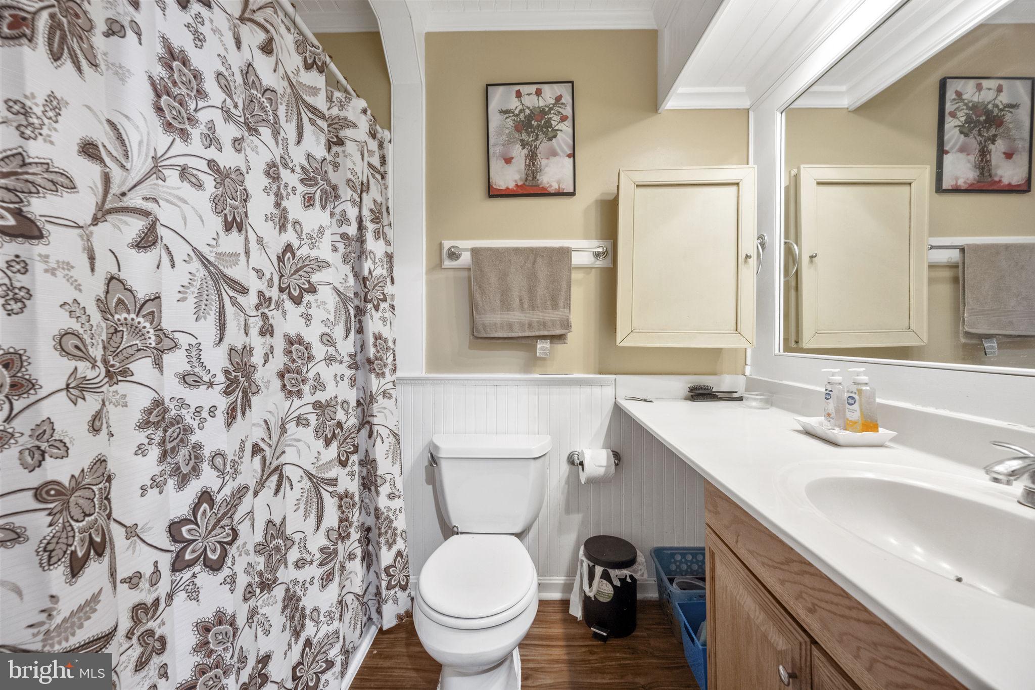 8527 Stonewall Road Manassas, VA 20110 - Photo 20 of 26 a bathroom with a toilet sink and mirror