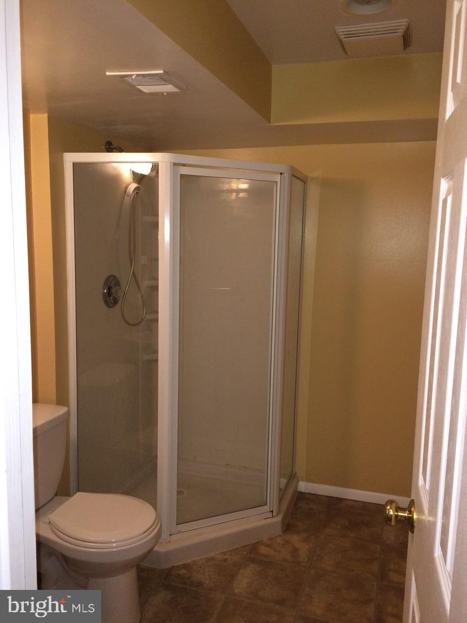 8527 Stonewall Road Manassas, VA 20110 - Photo 24 of 26 a bathroom with a toilet and a shower