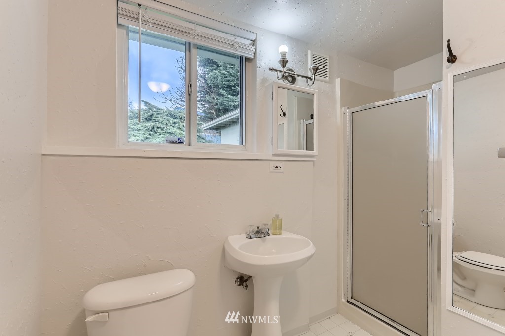 2608 Northeast 5th Place Renton, WA 98056 - Photo 22 of 29 a bathroom with a sink a toilet and a mirror