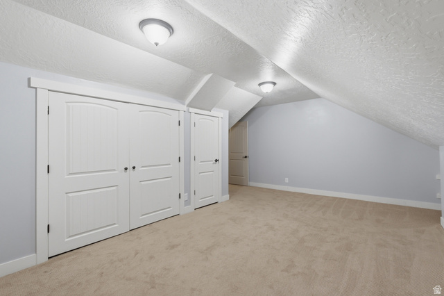 2567 West Rim Rock Drive Stockton, UT 84071 - Photo 35 of 64 Carpeted room featuring white trim and baseboards, light blue walls, and multiple white panel doors