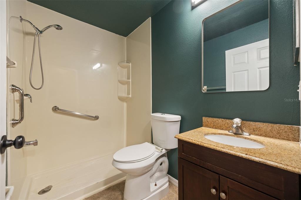 12112 Luftburrow Lane Hudson, FL 34669 - Photo 12 of 35 a bathroom with a granite countertop sink toilet and shower