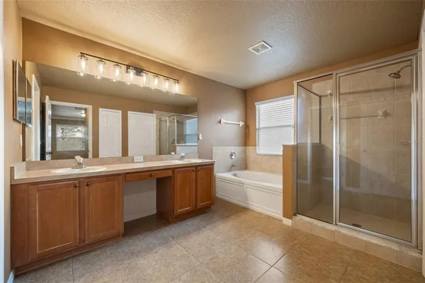 a large bathroom with a large tub shower and sink