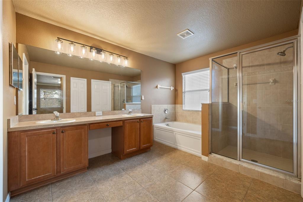 12112 Luftburrow Lane Hudson, FL 34669 - Photo 17 of 35 a large bathroom with a large tub shower and sink