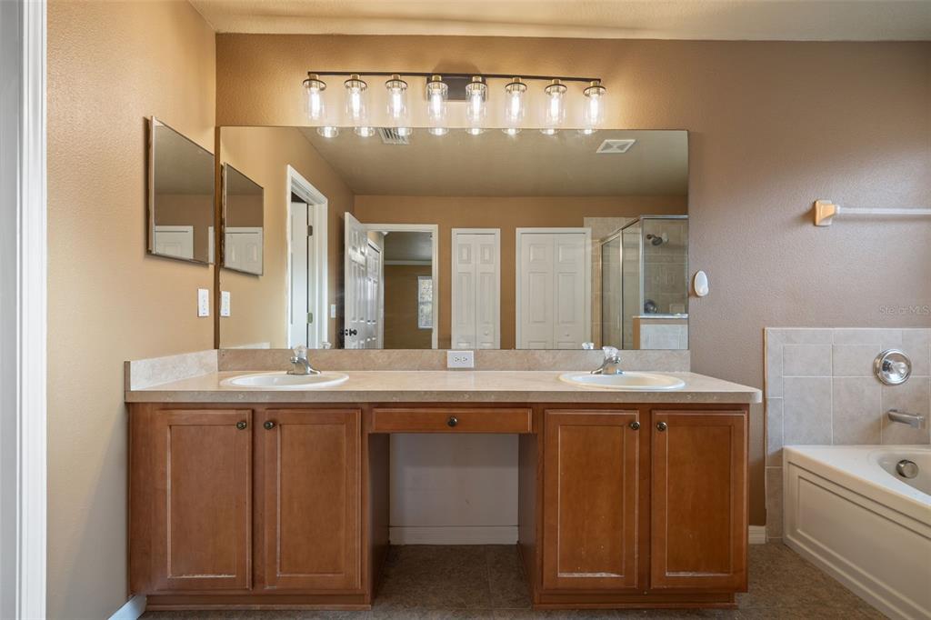 12112 Luftburrow Lane Hudson, FL 34669 - Photo 18 of 35 a bathroom with a granite countertop sink a toilet and a mirror