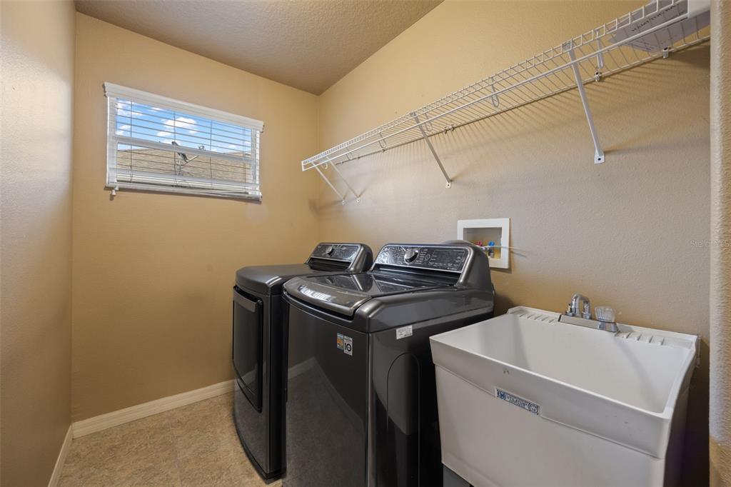 12112 Luftburrow Lane Hudson, FL 34669 - Photo 20 of 35 a utility room with dryer and washer