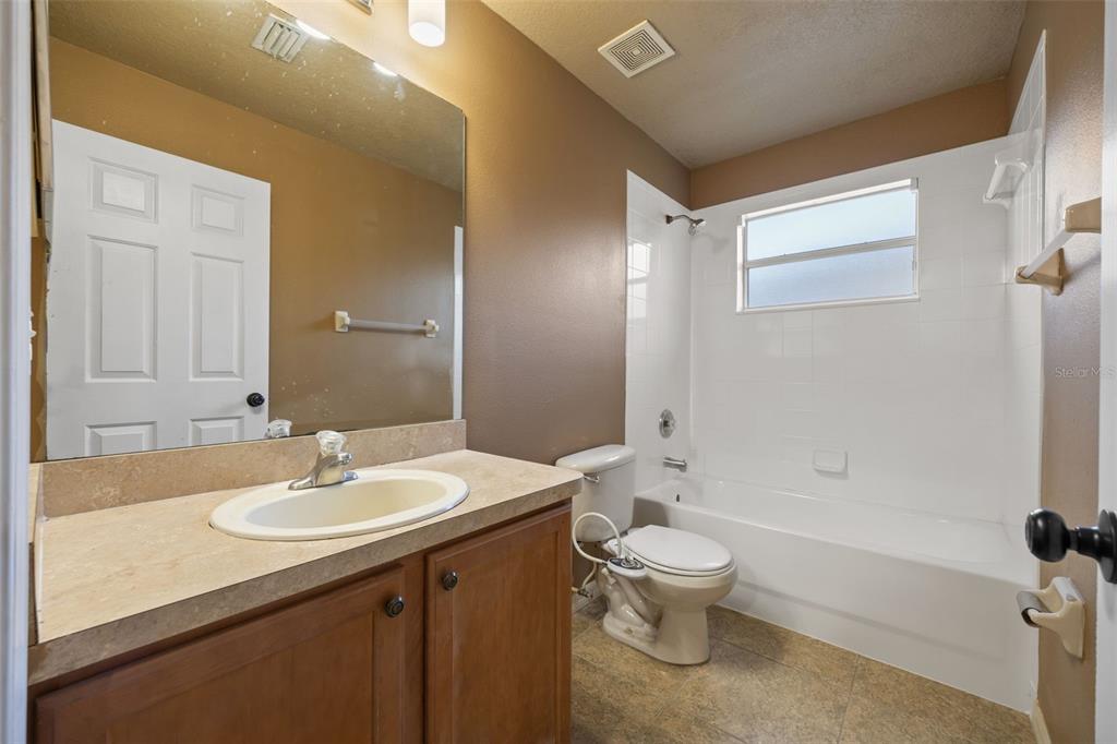 12112 Luftburrow Lane Hudson, FL 34669 - Photo 25 of 35 a bathroom with a sink a toilet and shower