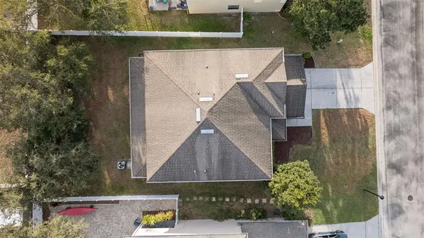 an aerial view of a house with a yard