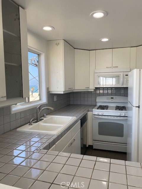 205 Shell Street Manhattan Beach, CA 90266 - Photo 5 of 7 a kitchen with a sink stove and cabinets