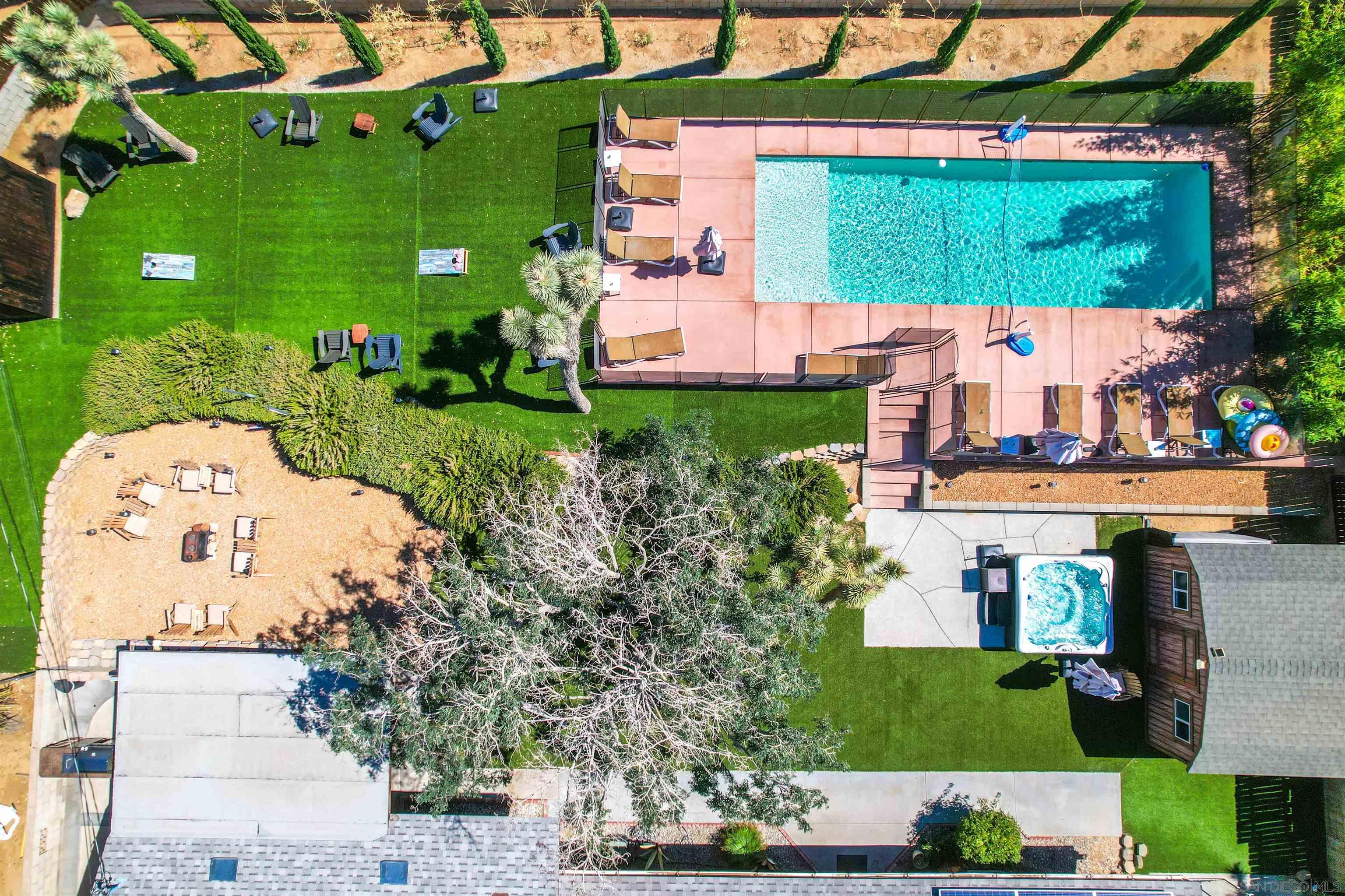 an aerial view of a house with a garden and a car park side