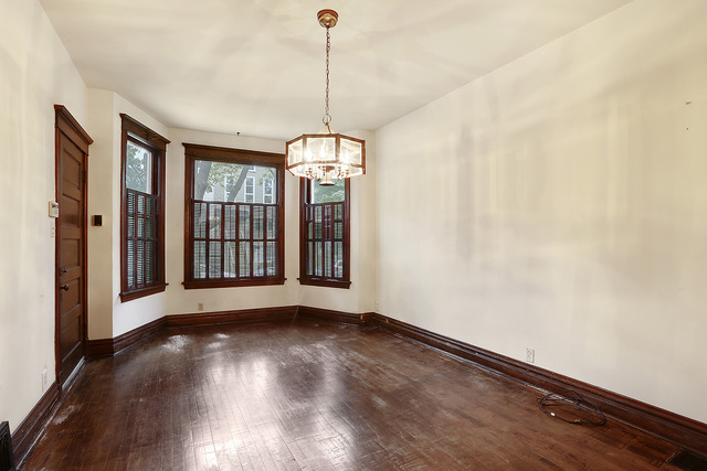 1745 West School Street Chicago, IL 60657 - Photo 2 of 12 a view of an empty room with wooden floor and a window
