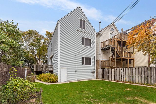 1745 West School Street Chicago, IL 60657 - Photo 11 of 12 a front view of a house with a yard
