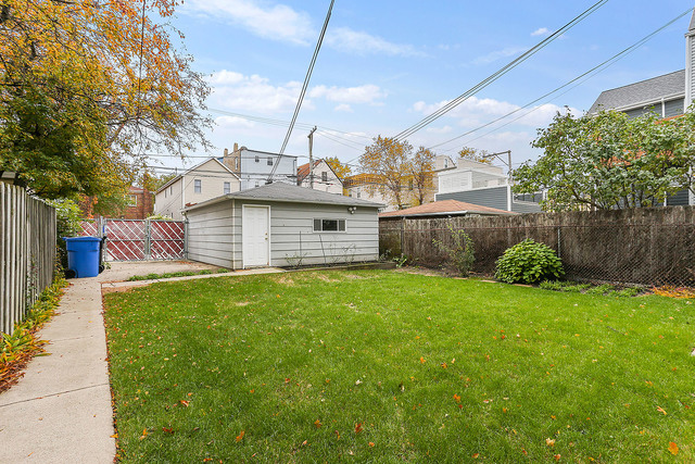 1745 West School Street Chicago, IL 60657 - Photo 12 of 12 a view of a backyard with barn plants and large tree