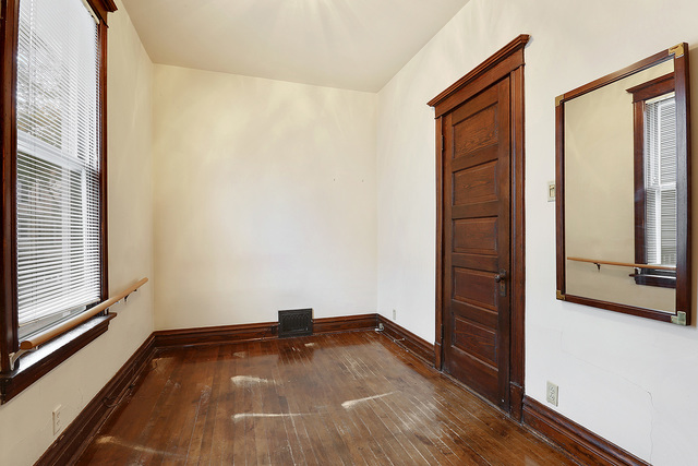 1745 West School Street Chicago, IL 60657 - Photo 5 of 12 an empty room with wooden floor and windows
