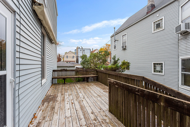 1745 West School Street Chicago, IL 60657 - Photo 10 of 12 a balcony with wooden floor and next to a window