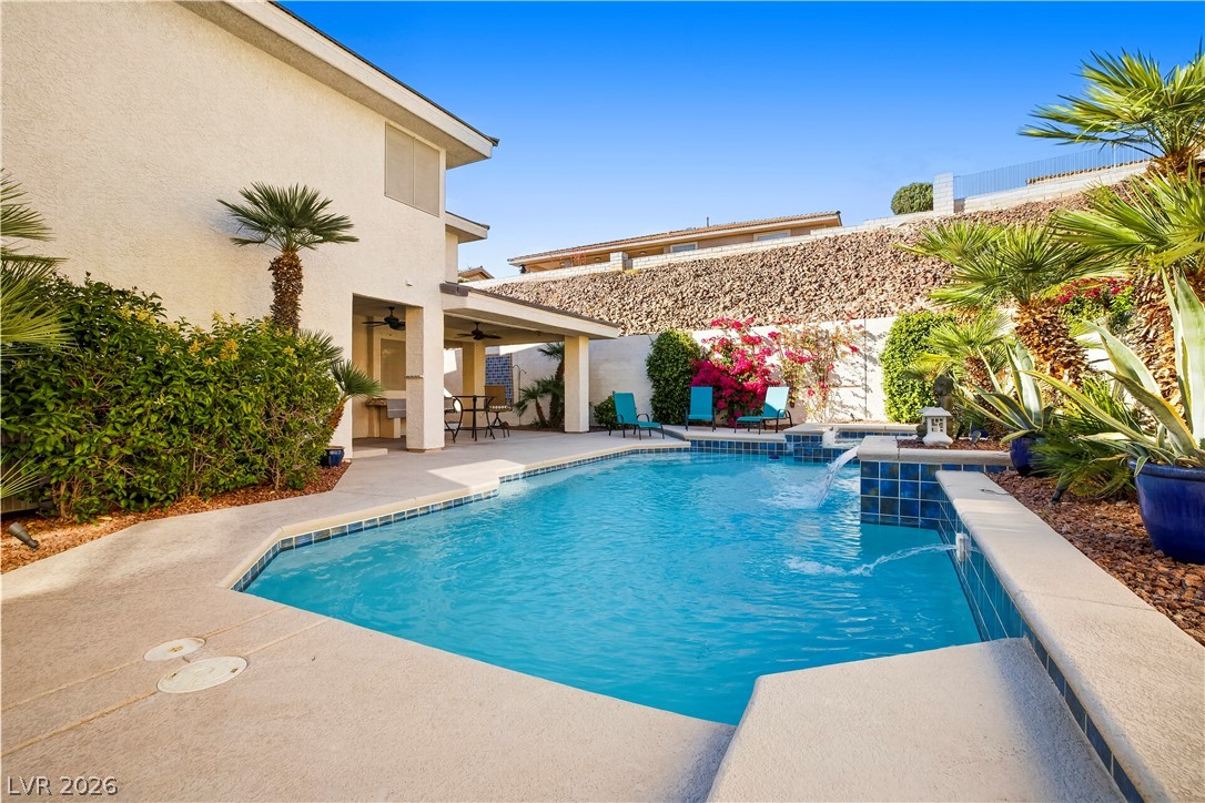 1135 Calico Ridge Drive Henderson, NV 89011 - Photo 51 of 86 A private backyard oasis features a shimmering pool, spa, and covered patio for ultimate relaxation.