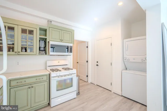 a kitchen with stainless steel appliances white cabinets and a stove top oven