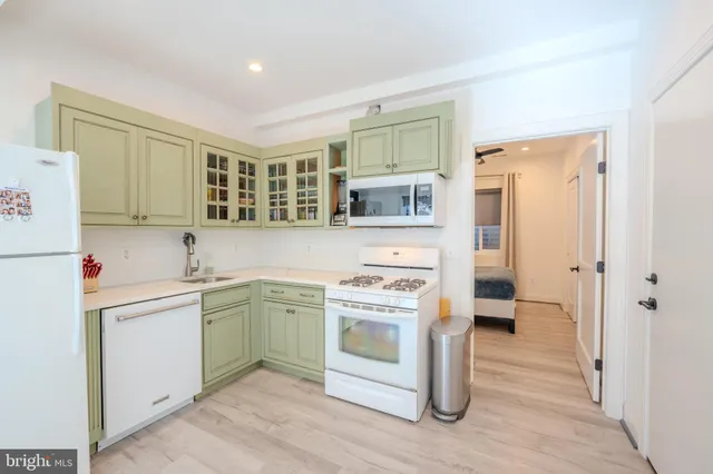 a kitchen with a stove top oven sink and cabinets