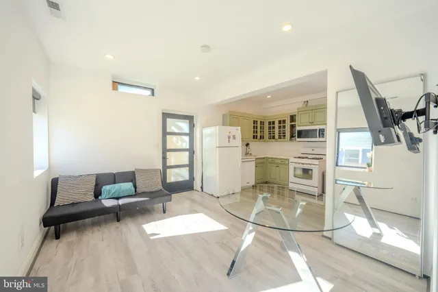a living room with furniture and kitchen view