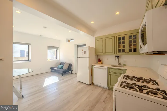 a kitchen with a stove and a refrigerator