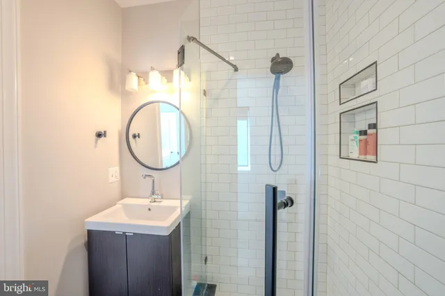 a bathroom with a sink a toilet and a shower