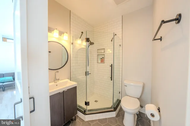 a bathroom with a granite countertop toilet sink and shower