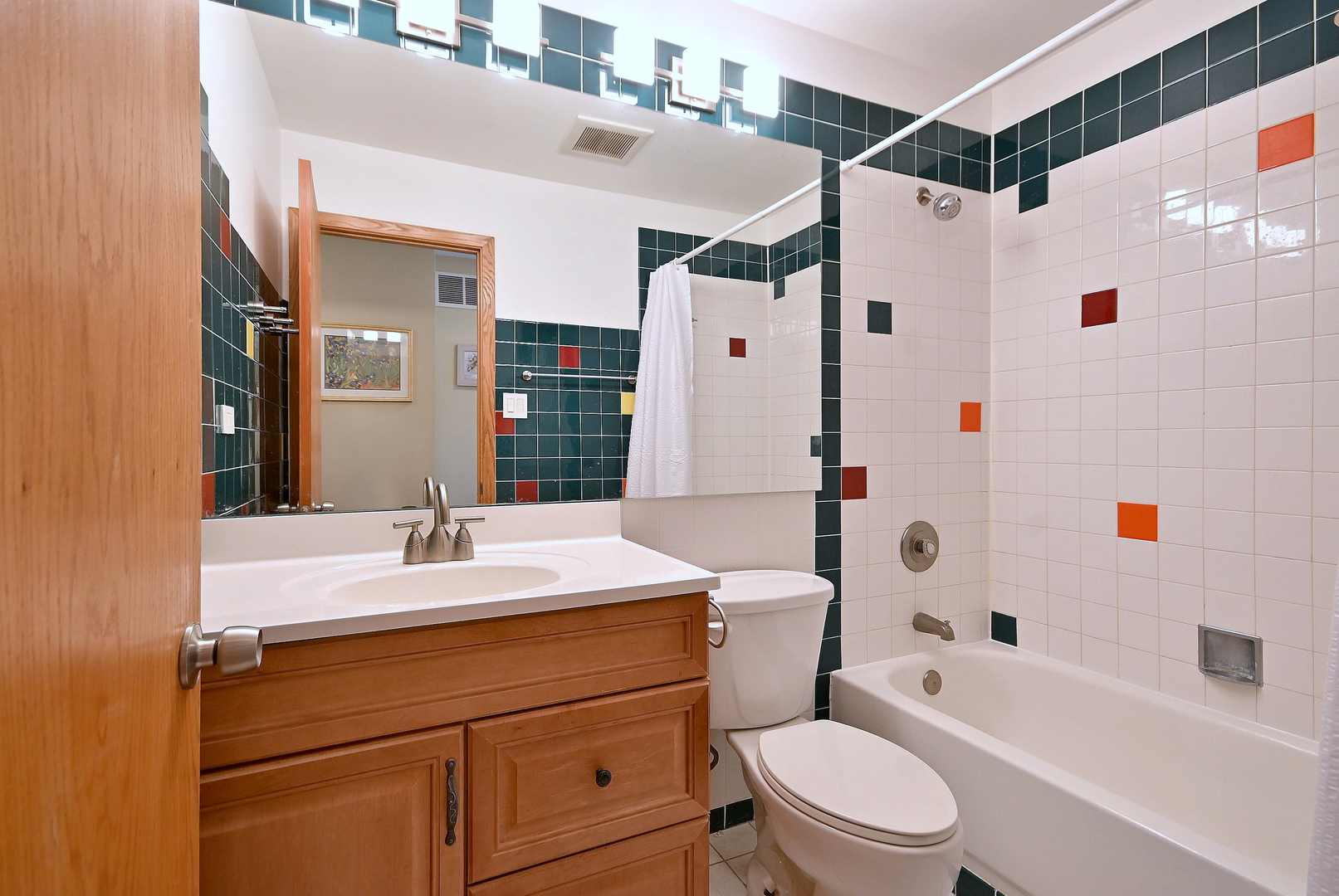 2350 North Sayre Avenue, Unit G Chicago, IL 60707 - Photo 16 of 30 a bathroom with a sink a toilet a mirror a vanity and shower