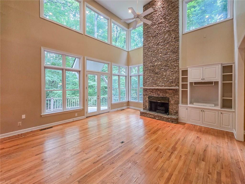3712 Frederica Road Northwest Berkeley Lake, GA 30096 - Photo 11 of 49 a view of empty room with wooden floor and fireplace