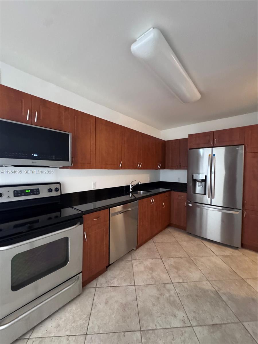 401 69th Street, Unit 607 Miami Beach, FL 33141 - Photo 14 of 89 a kitchen with stainless steel appliances granite countertop a stove a microwave and a refrigerator