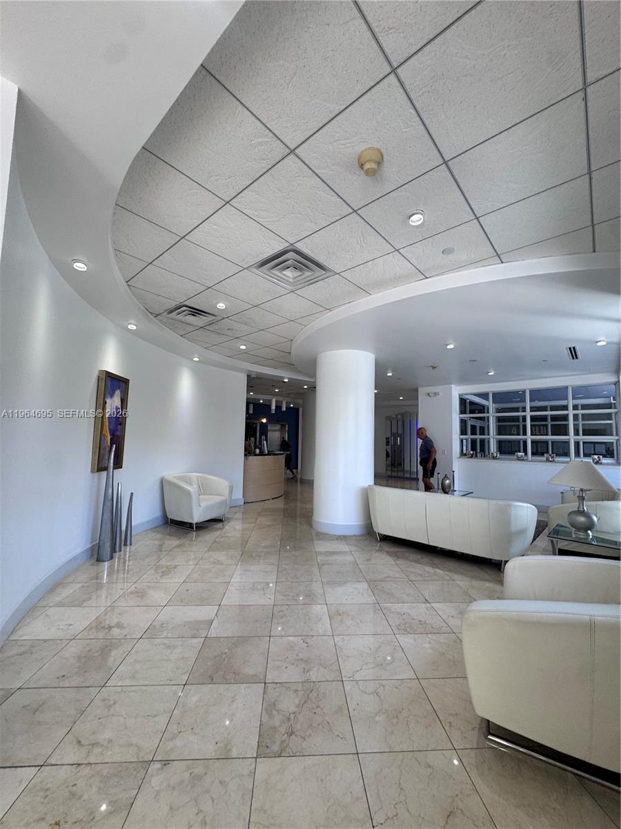 401 69th Street, Unit 607 Miami Beach, FL 33141 - Photo 27 of 89 a living room with furniture and a chandelier