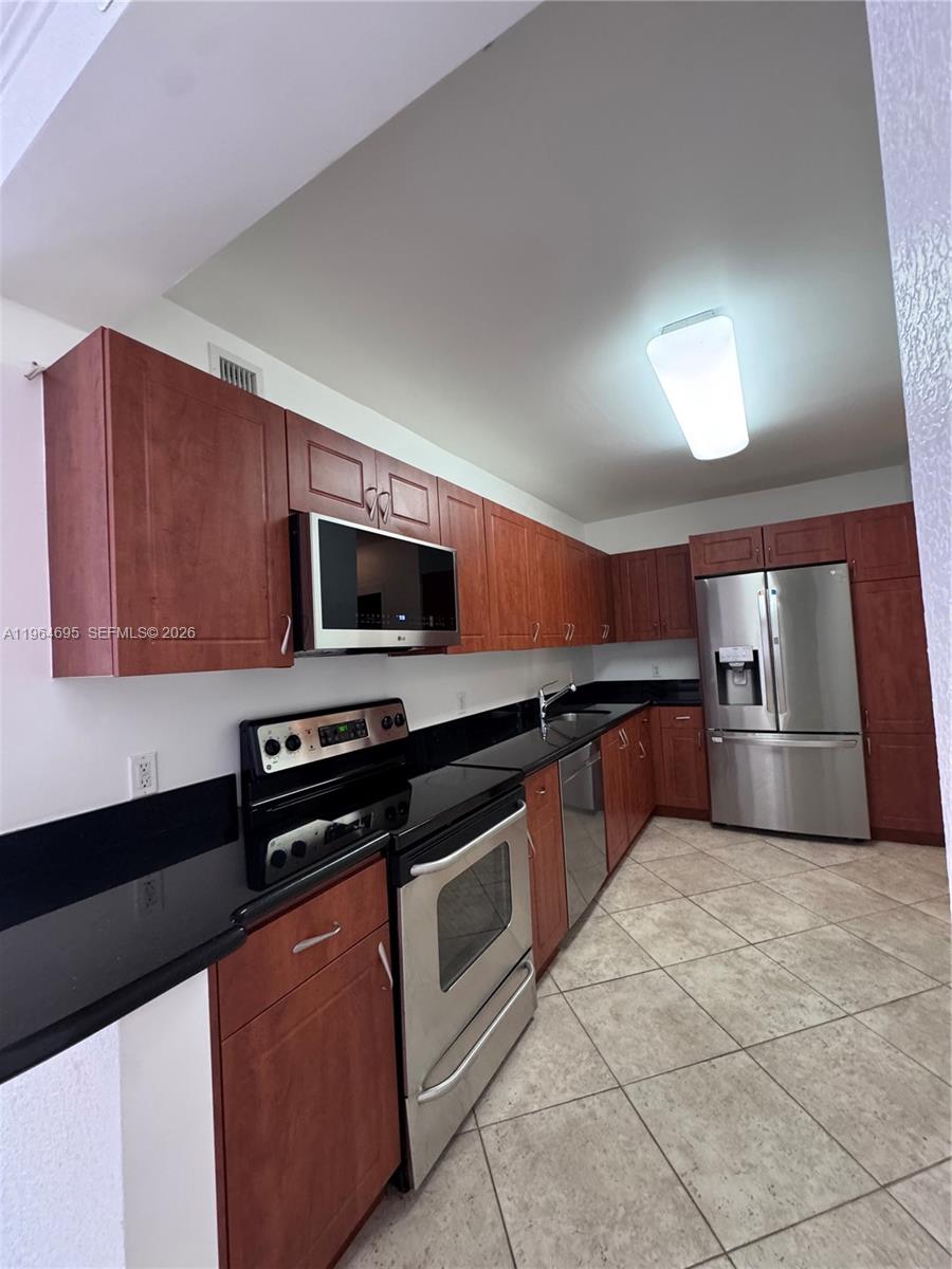401 69th Street, Unit 607 Miami Beach, FL 33141 - Photo 3 of 89 a kitchen with stainless steel appliances a sink dishwasher stove top oven and refrigerator