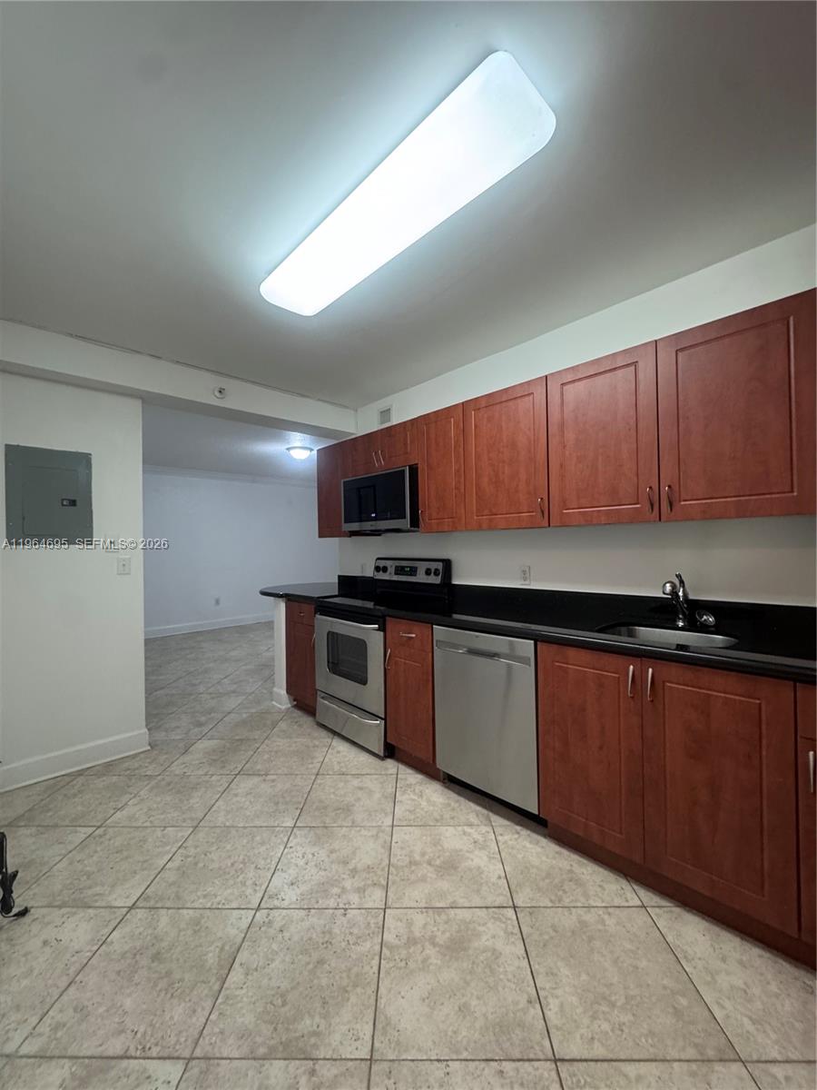 401 69th Street, Unit 607 Miami Beach, FL 33141 - Photo 4 of 89 a kitchen with stainless steel appliances granite countertop a stove and a refrigerator