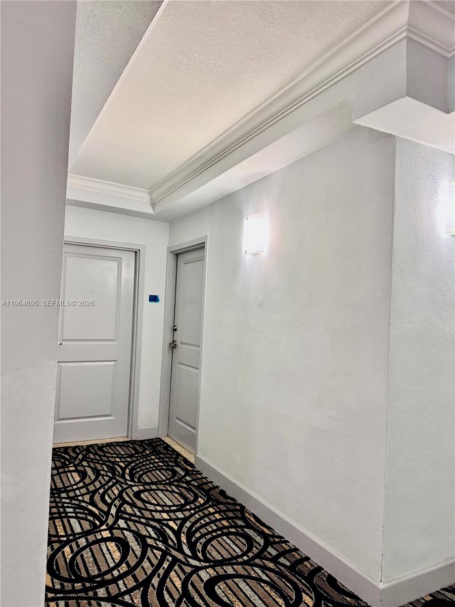 401 69th Street, Unit 607 Miami Beach, FL 33141 - Photo 46 of 89 a room with a walk in closet and wooden floor