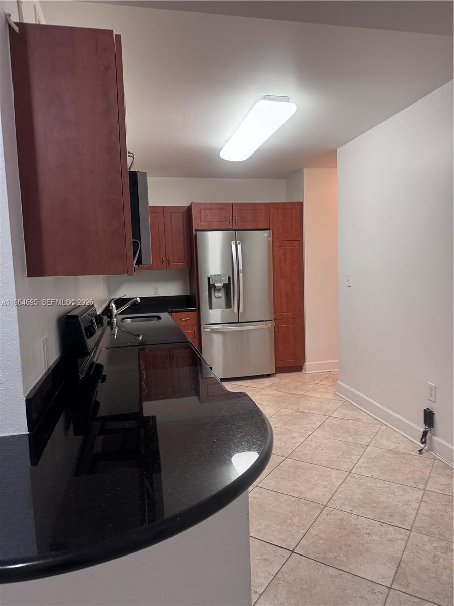 401 69th Street, Unit 607 Miami Beach, FL 33141 - Photo 5 of 89 a kitchen with a sink and a refrigerator