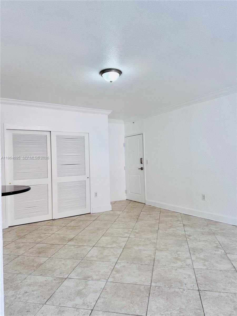 401 69th Street, Unit 607 Miami Beach, FL 33141 - Photo 53 of 89 an empty room with cabinet and mirrors