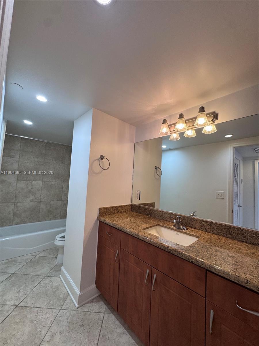 401 69th Street, Unit 607 Miami Beach, FL 33141 - Photo 62 of 89 a bathroom with a sink and a mirror