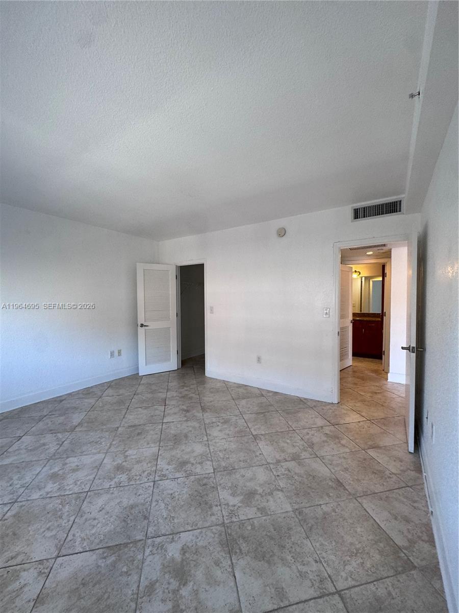 401 69th Street, Unit 607 Miami Beach, FL 33141 - Photo 63 of 89 a view of an empty room with closet and windows