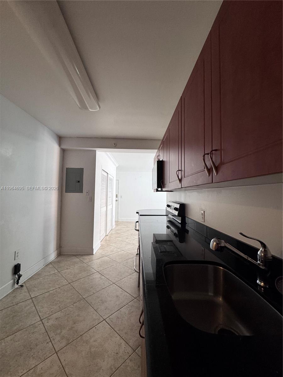 401 69th Street, Unit 607 Miami Beach, FL 33141 - Photo 78 of 89 a kitchen with a sink appliances and cabinets
