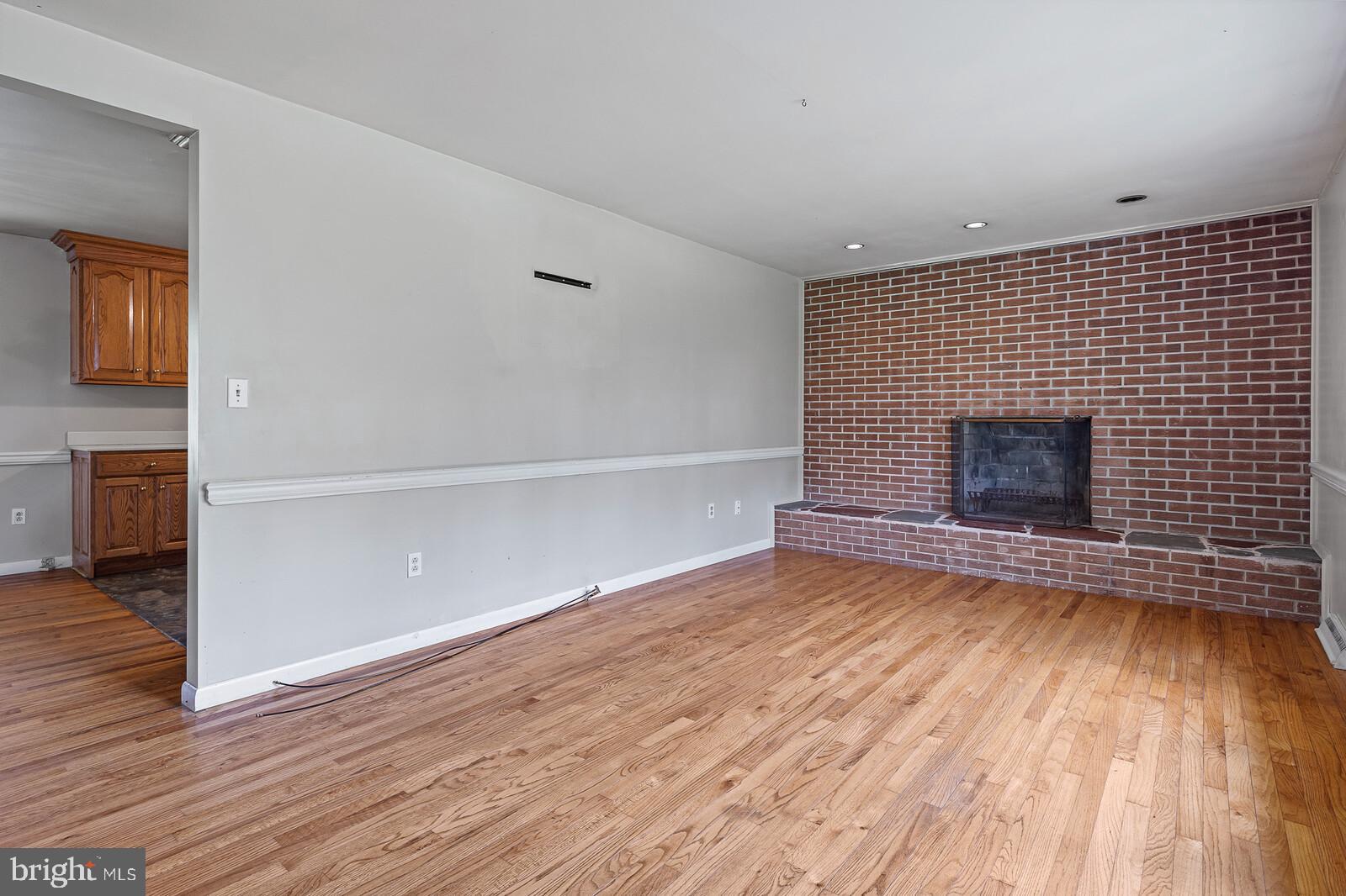 57 Elk Forest Road Elkton, MD 21921 - Photo 9 of 21 Living room, hardwood floor, woodburning fireplace