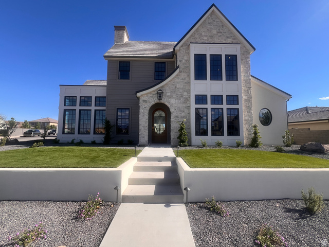 3320 Clara Lane St. George, UT 84790 - Photo 1 of 1 Custom-built residence featuring a stone and stucco exterior with a prominent arched entry