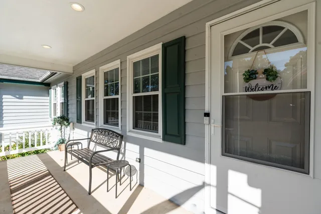 a view of a porch with chairs and backyard