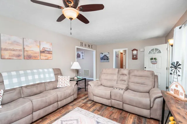 a living room with furniture and a chandelier