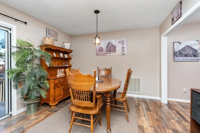 a dining room with furniture and wooden floor