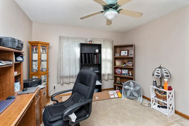 a living room with furniture a couch and bookshelf