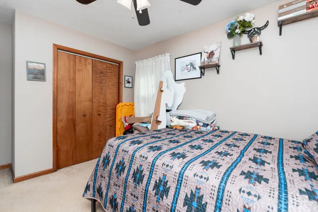 a bed sitting in a bedroom next to a window