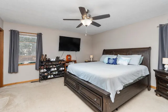 a bed room with a bed and flat screen tv